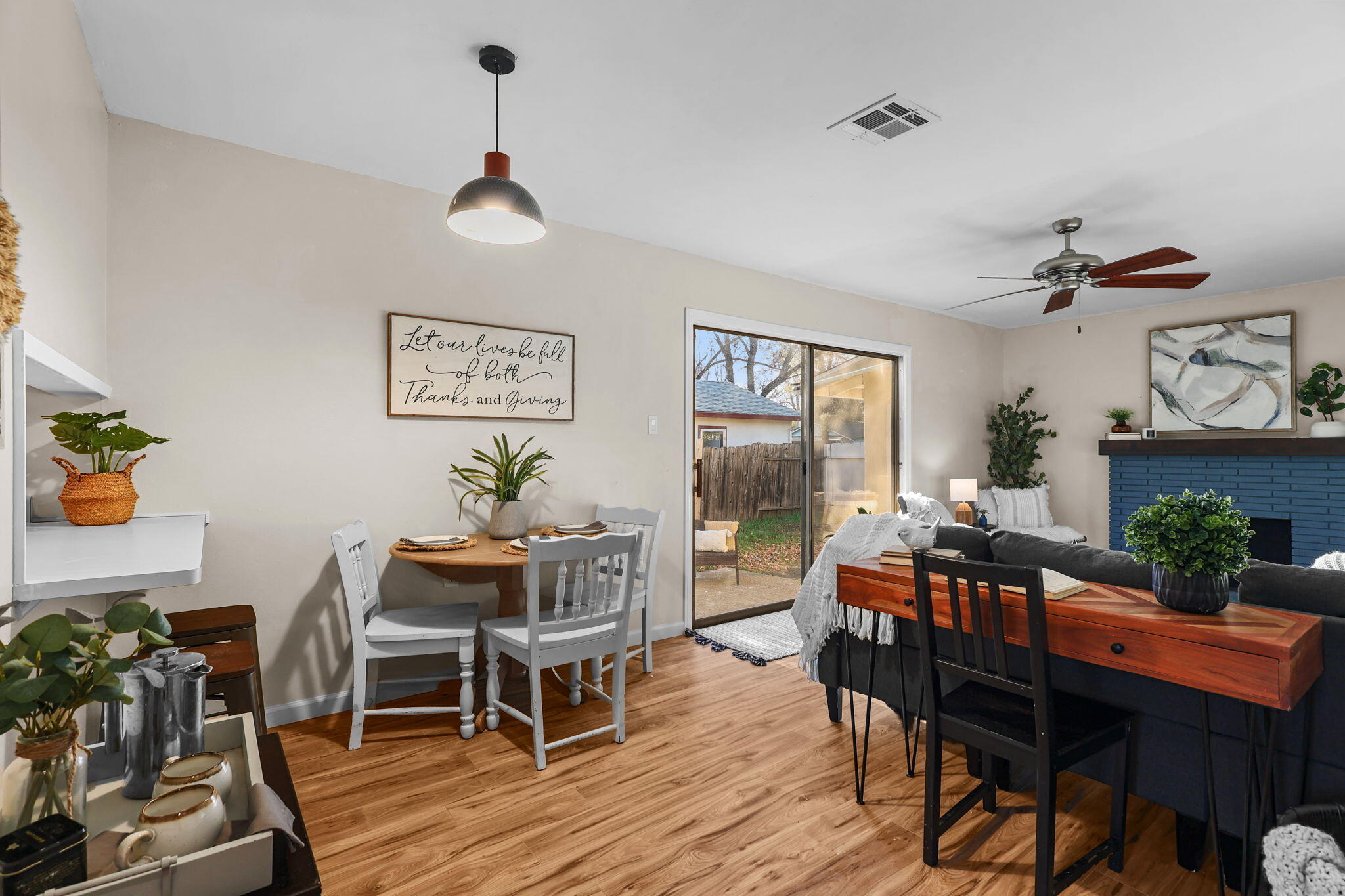 755 Christine Avenue Redding, CA 96003 - Photo 5 of 58 a dining room with wooden floor a chandelier a wooden table and chairs