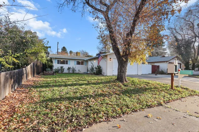 an aerial view of residential house with parking