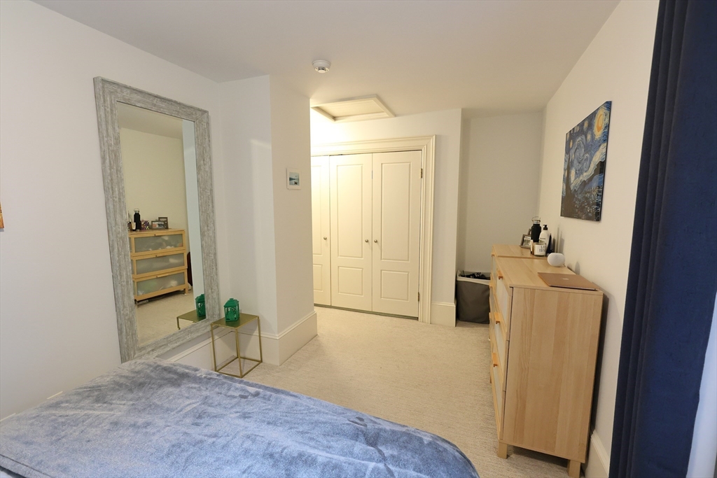 107 Waban Hill Road, Unit R Newton, MA 02467 - Photo 17 of 21 a view of a hallway with bathroom and wooden floor
