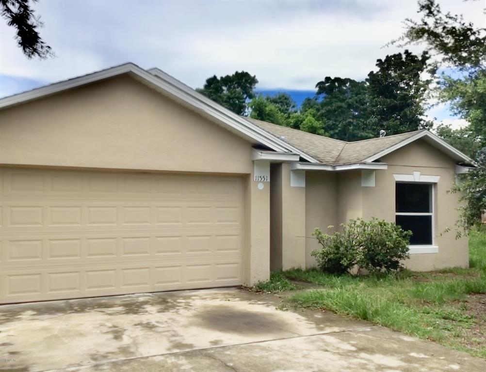 11551 Rancho Drive Leesburg, FL 34788 - Photo 1 of 1 a view of a house with a yard