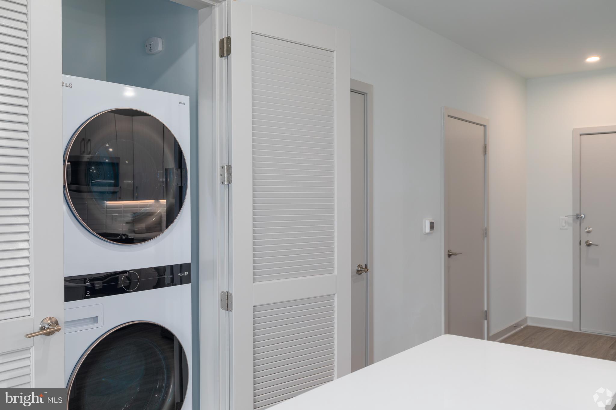 6461 Highway 9, Unit 142 Howell, NJ 07731 - Photo 10 of 29 a bedroom with a bed and a washing machine