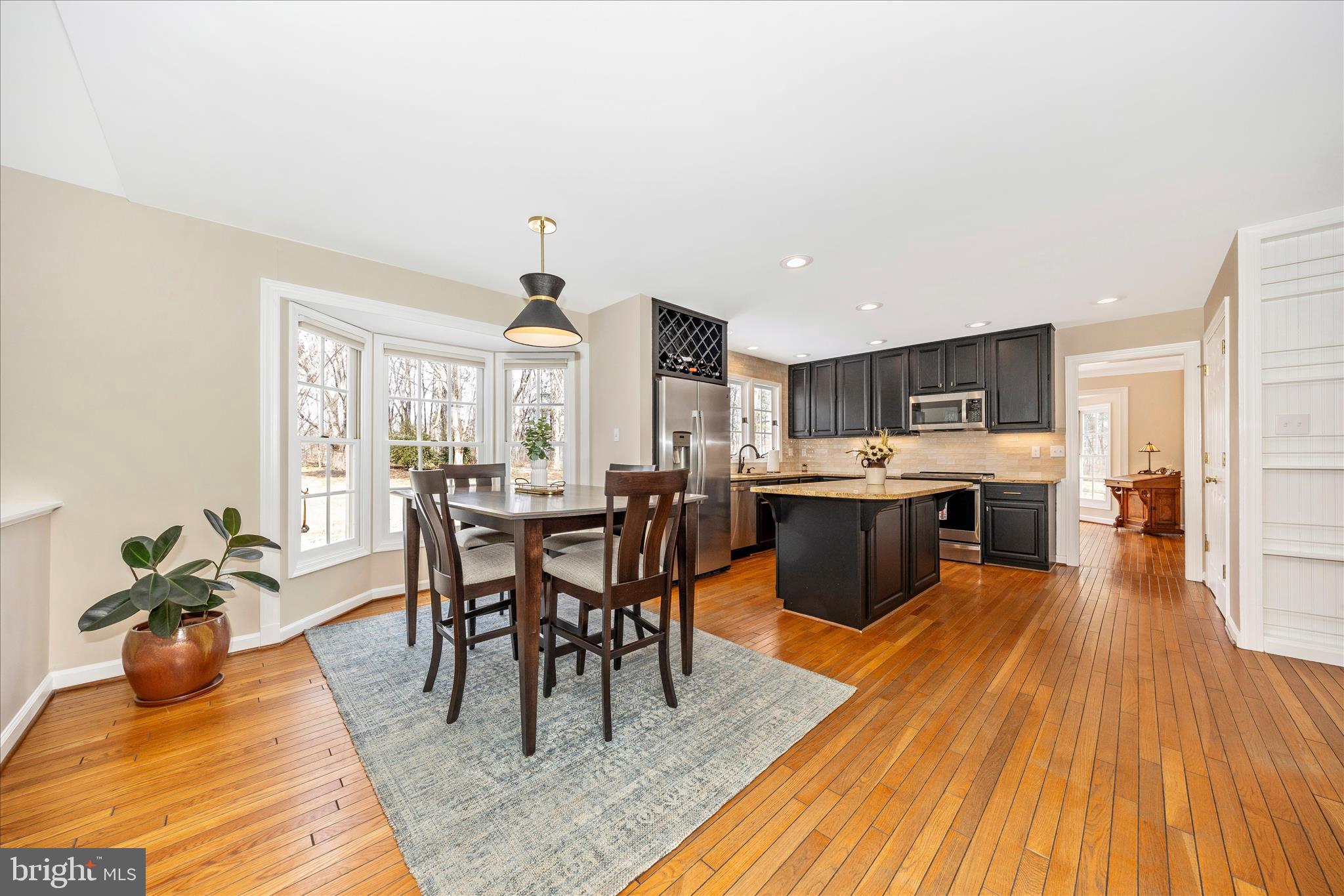 6135 Cornwall Place Frederick, MD 21701 - Photo 19 of 81 a view of a dining room with furniture window and wooden floor