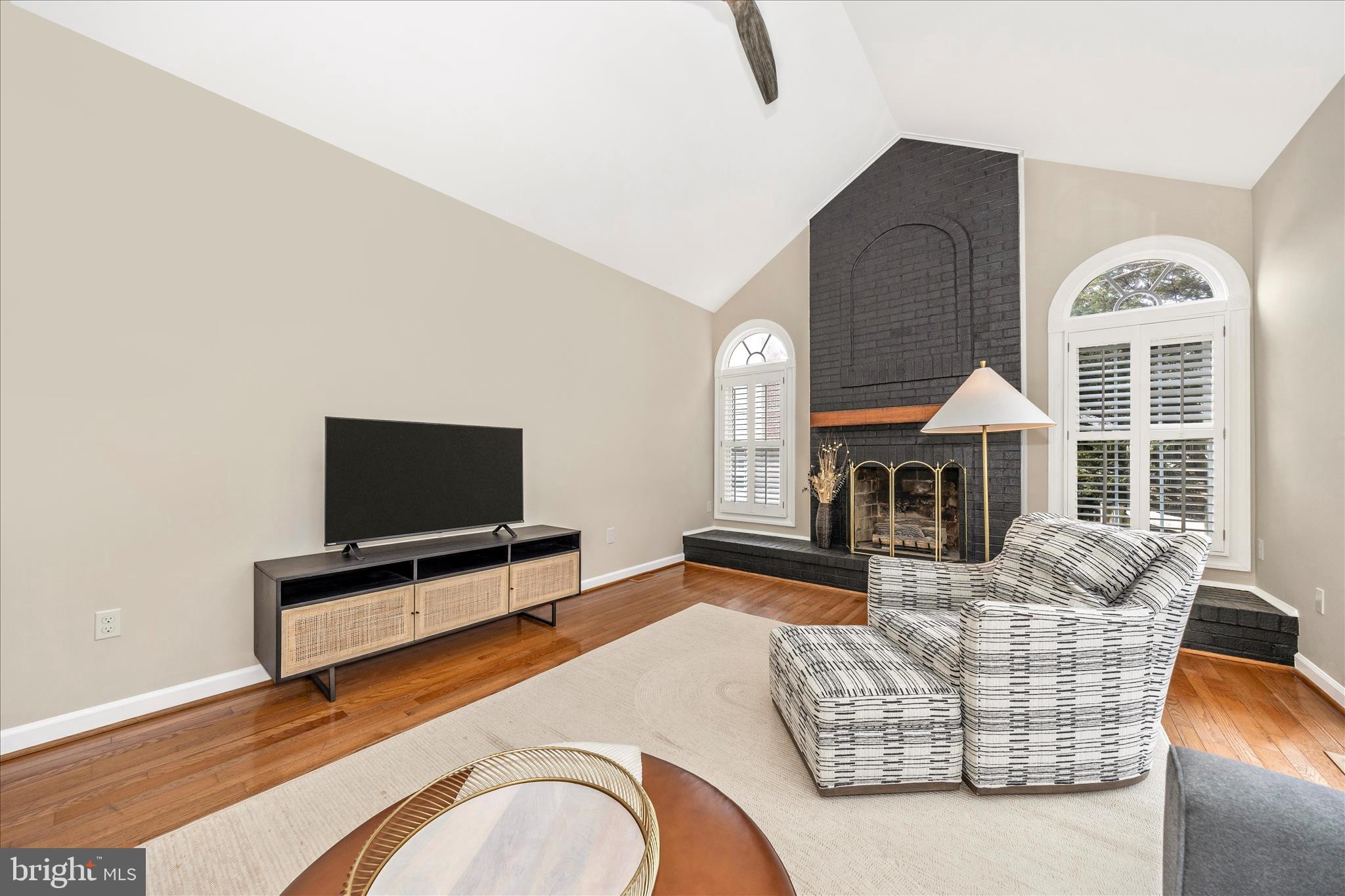 6135 Cornwall Place Frederick, MD 21701 - Photo 24 of 81 a living room with furniture a fireplace and a flat screen tv