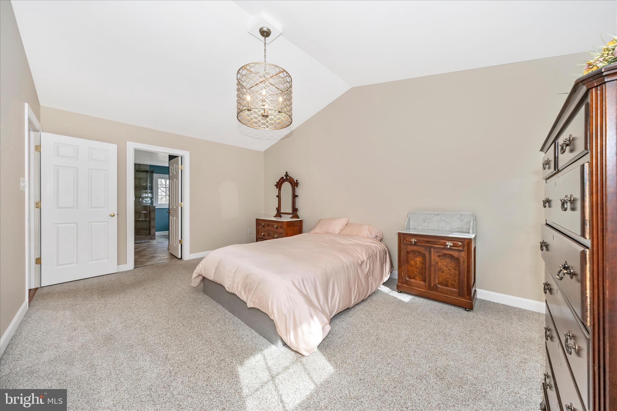 6135 Cornwall Place Frederick, MD 21701 - Photo 31 of 81 a bedroom with a bed and a chandelier