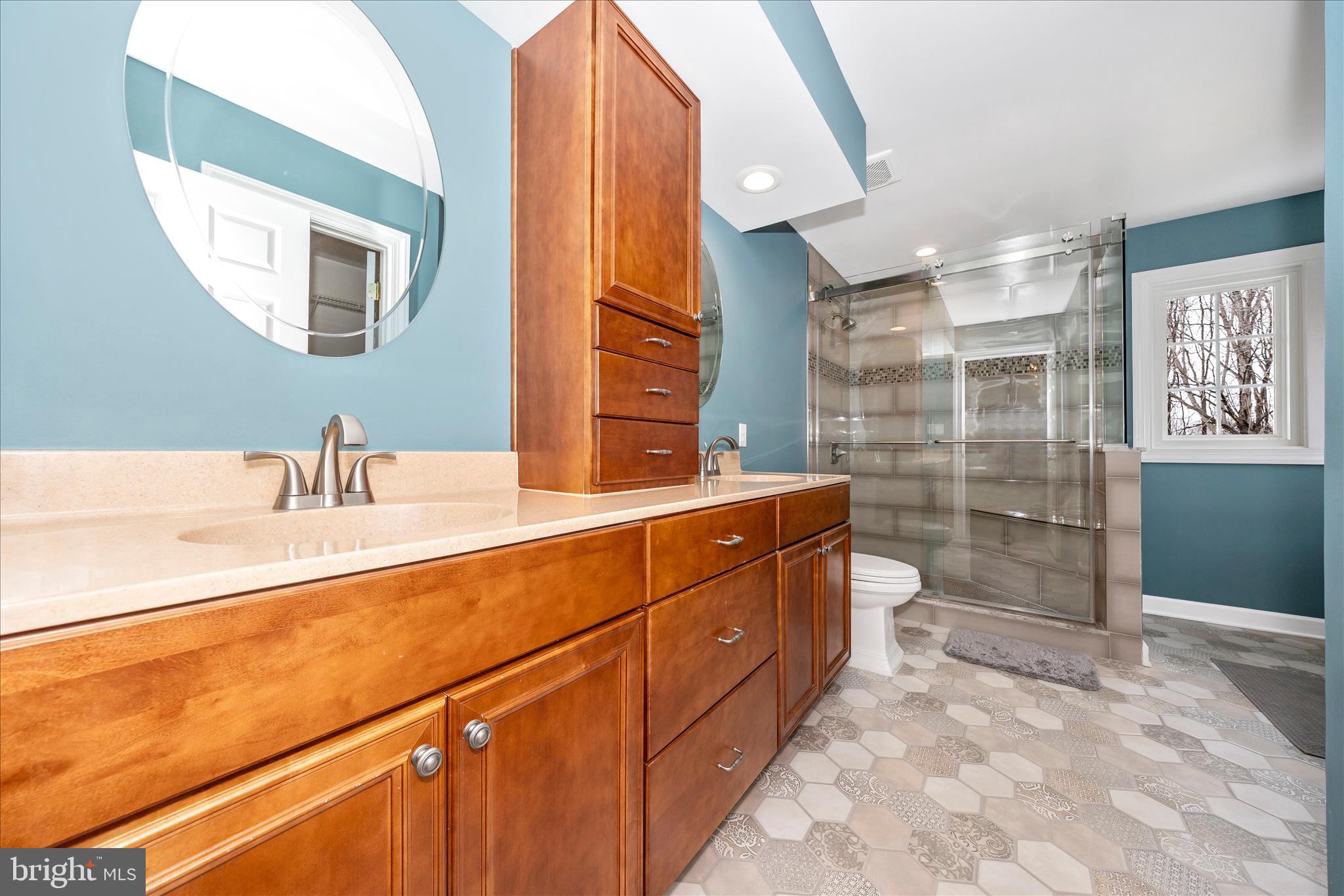 6135 Cornwall Place Frederick, MD 21701 - Photo 32 of 81 a bathroom with a double vanity sink mirror and shower