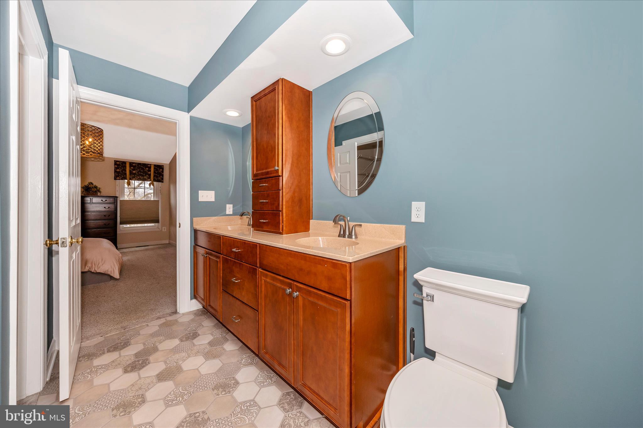 6135 Cornwall Place Frederick, MD 21701 - Photo 34 of 81 a bathroom with a toilet sink and mirror