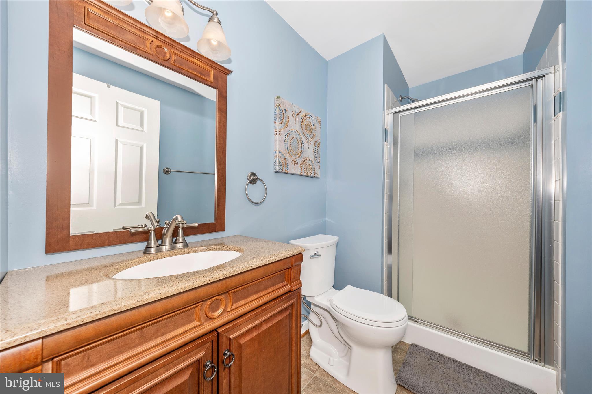 6135 Cornwall Place Frederick, MD 21701 - Photo 45 of 81 a bathroom with a sink a toilet and shower