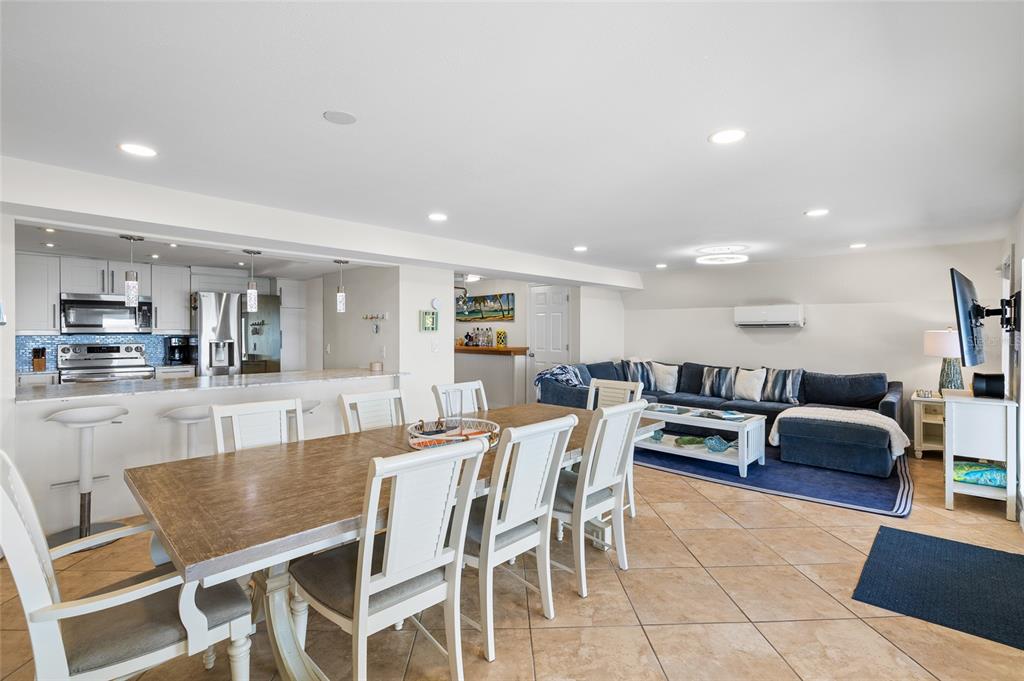 9664 Privateer Road Boca Grande, FL 33921 - Photo 13 of 66 a dining area with stainless steel appliances kitchen island granite countertop a dining table chairs and view living room