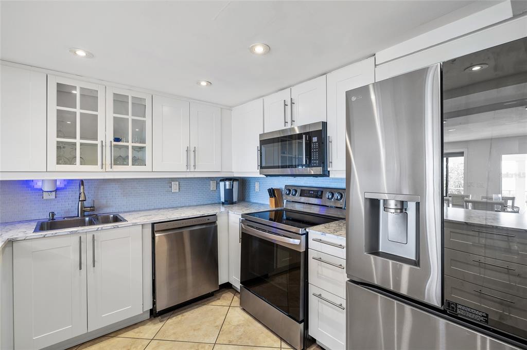9664 Privateer Road Boca Grande, FL 33921 - Photo 17 of 66 a kitchen with cabinets stainless steel appliances and sink