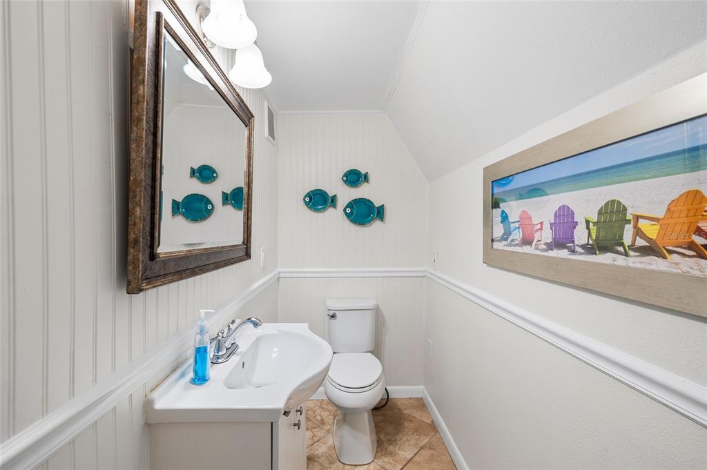 9664 Privateer Road Boca Grande, FL 33921 - Photo 18 of 66 a bathroom with a toilet sink and mirror