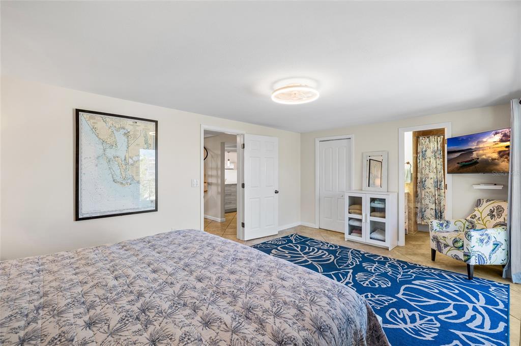 9664 Privateer Road Boca Grande, FL 33921 - Photo 19 of 66 a bedroom with a large bed and a window