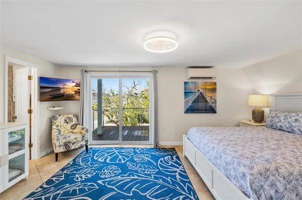 a bedroom with a large bed and a window