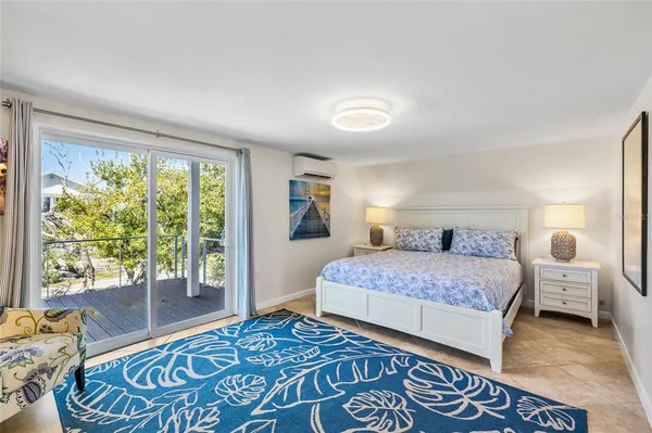 a very nice looking room with a dining table a mirror and a window