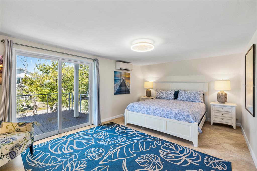 9664 Privateer Road Boca Grande, FL 33921 - Photo 23 of 66 a bedroom with a large bed and a window