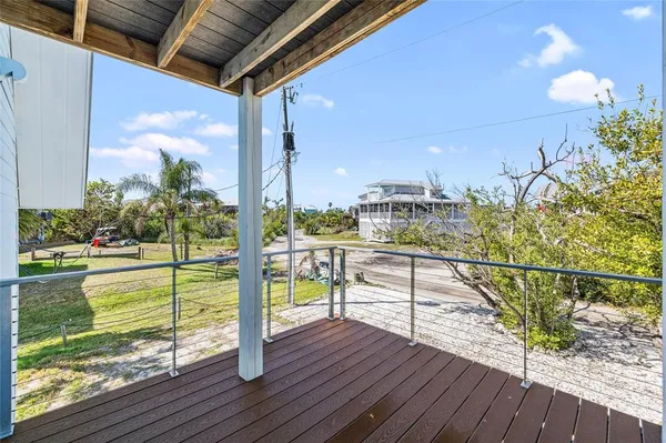 a view of balcony with wooden floor and fence