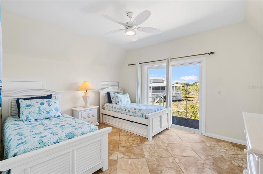 9664 Privateer Road Boca Grande, FL 33921 - Photo 30 of 66 a bedroom with a bed and a window