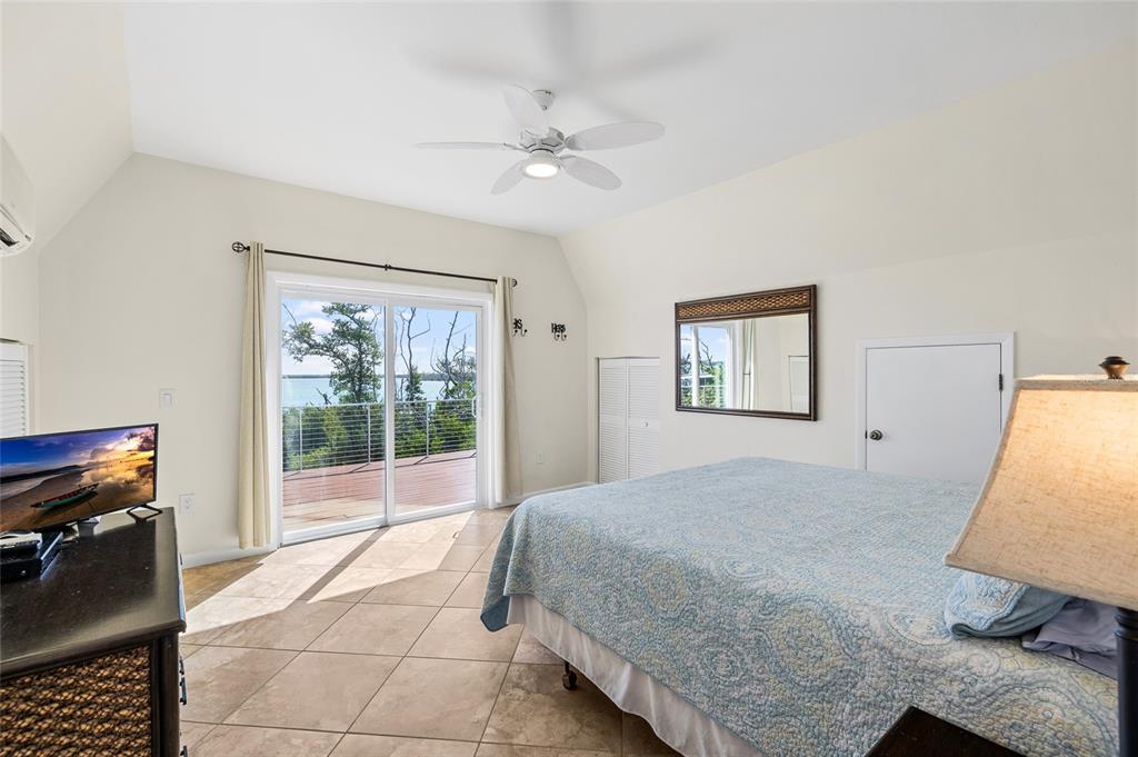 9664 Privateer Road Boca Grande, FL 33921 - Photo 35 of 66 a bedroom with a bed and a large window