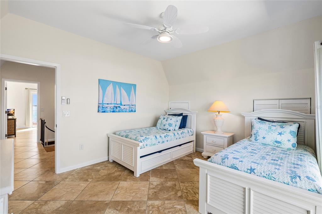 9664 Privateer Road Boca Grande, FL 33921 - Photo 38 of 66 a bedroom with a bed and a lamp on table