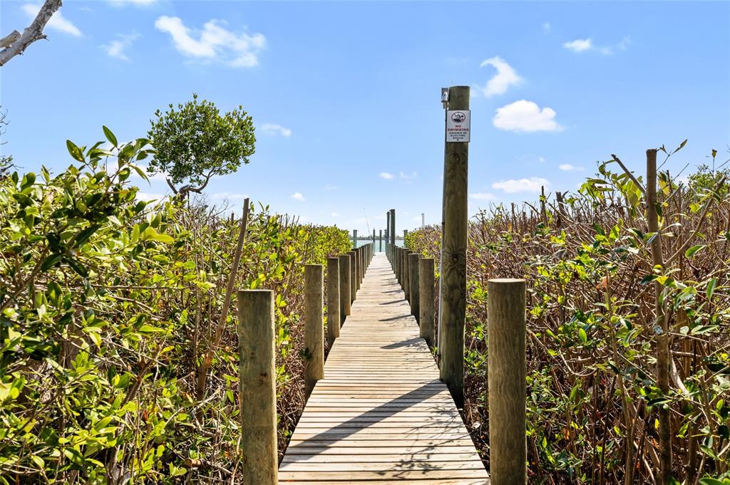 9664 Privateer Road Boca Grande, FL 33921 - Photo 41 of 66 a view of a balcony with wooden floor and a bench
