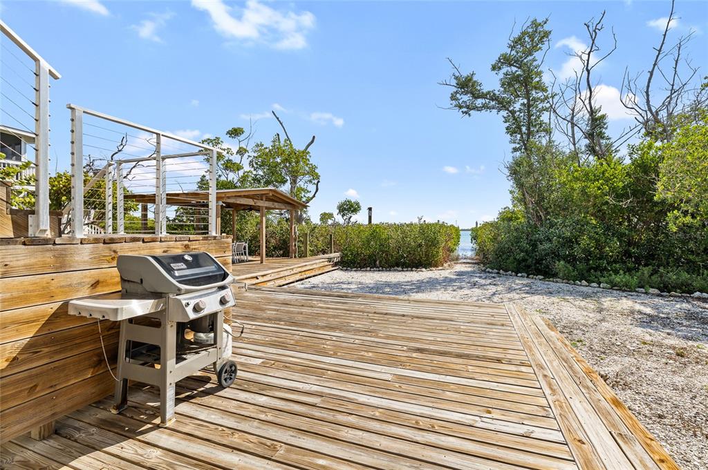 9664 Privateer Road Boca Grande, FL 33921 - Photo 48 of 66 a patio with glass top table and chairs