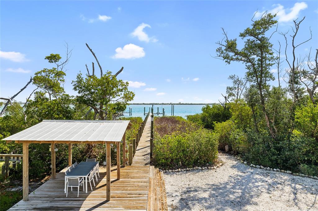 9664 Privateer Road Boca Grande, FL 33921 - Photo 6 of 66 a view of a chairs and table in the patio