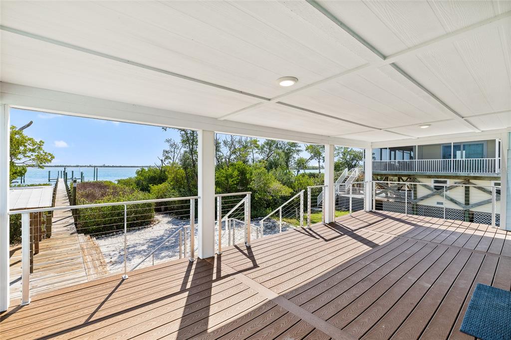 9664 Privateer Road Boca Grande, FL 33921 - Photo 8 of 66 a balcony with couch and wooden floor