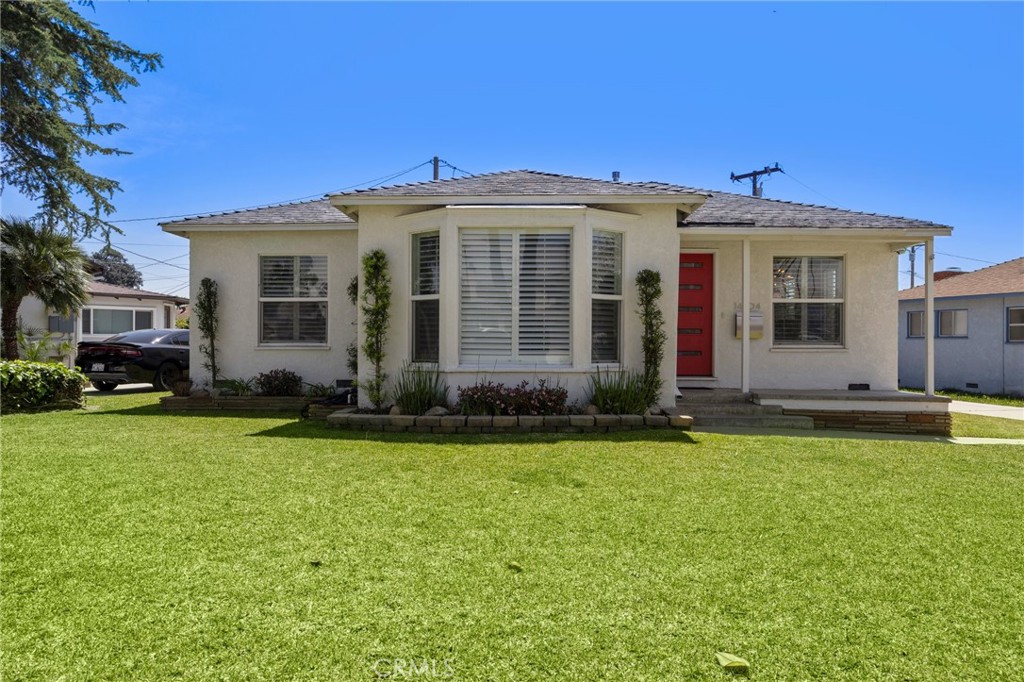 a front view of a house with a garden and porch
