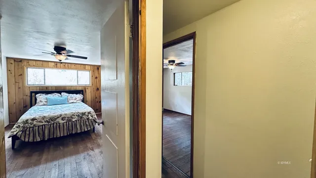a bedroom with a bed and a mirror