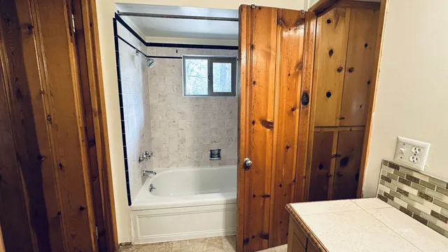 a bathroom with a bathtub and a shower