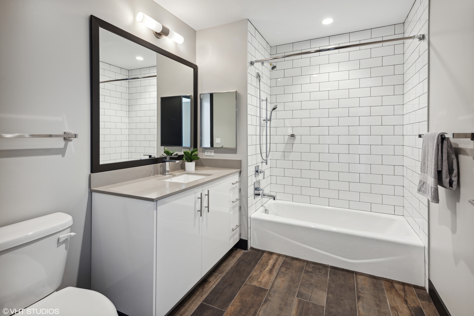 171 North Aberdeen Street, Unit 1008 Chicago, IL 60607 - Photo 11 of 25 a bathroom with a sink toilet and shower