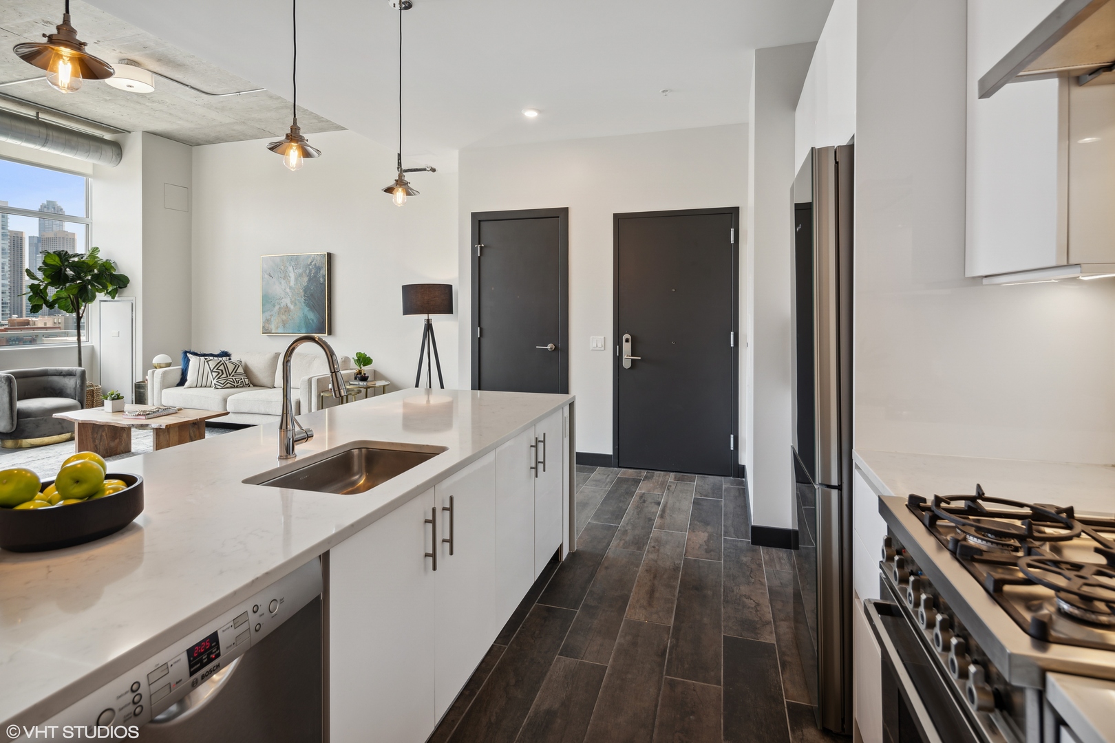 171 North Aberdeen Street, Unit 1008 Chicago, IL 60607 - Photo 7 of 25 a kitchen with counter top space a sink and stainless steel appliances