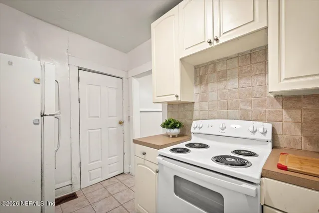 a kitchen with a stove and a refrigerator