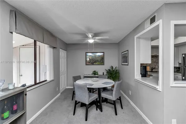 a dining room with furniture and window