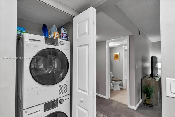 a view of a hallway with washer and dryer