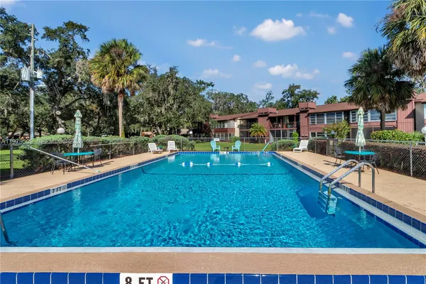 a view of a house with swimming pool and sitting area