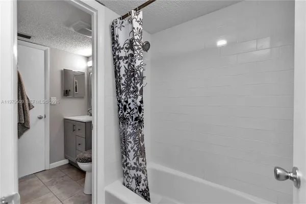 a bathroom with a shower and a sink