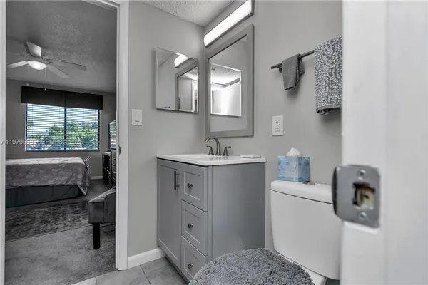 a bathroom with a sink toilet and mirror
