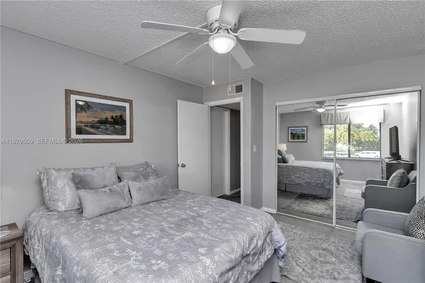 a bedroom with a large bed couch and a window