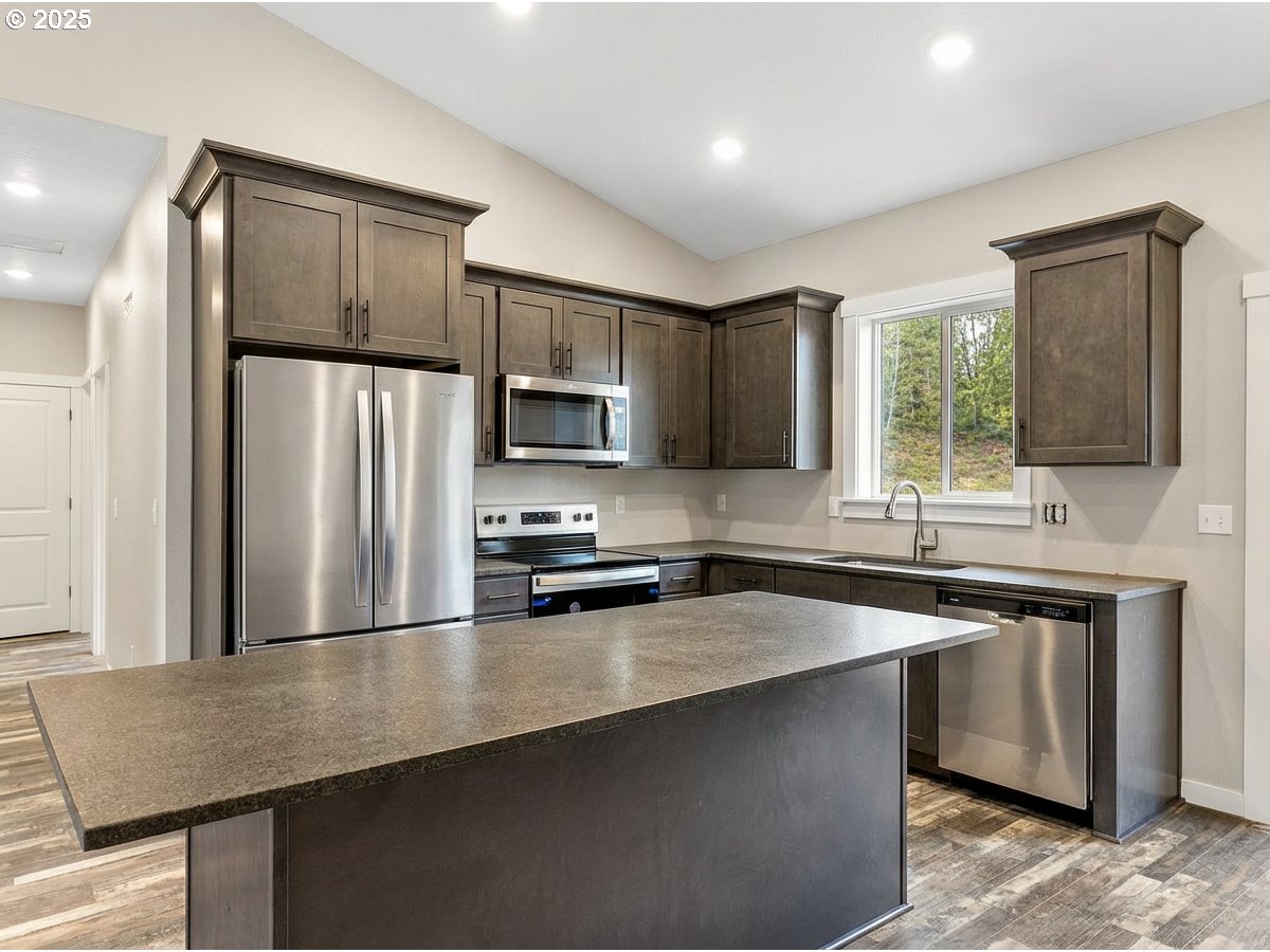 158 East H Street Vernonia, OR 97064 - Photo 12 of 33 a kitchen with stainless steel appliances a refrigerator sink and microwave