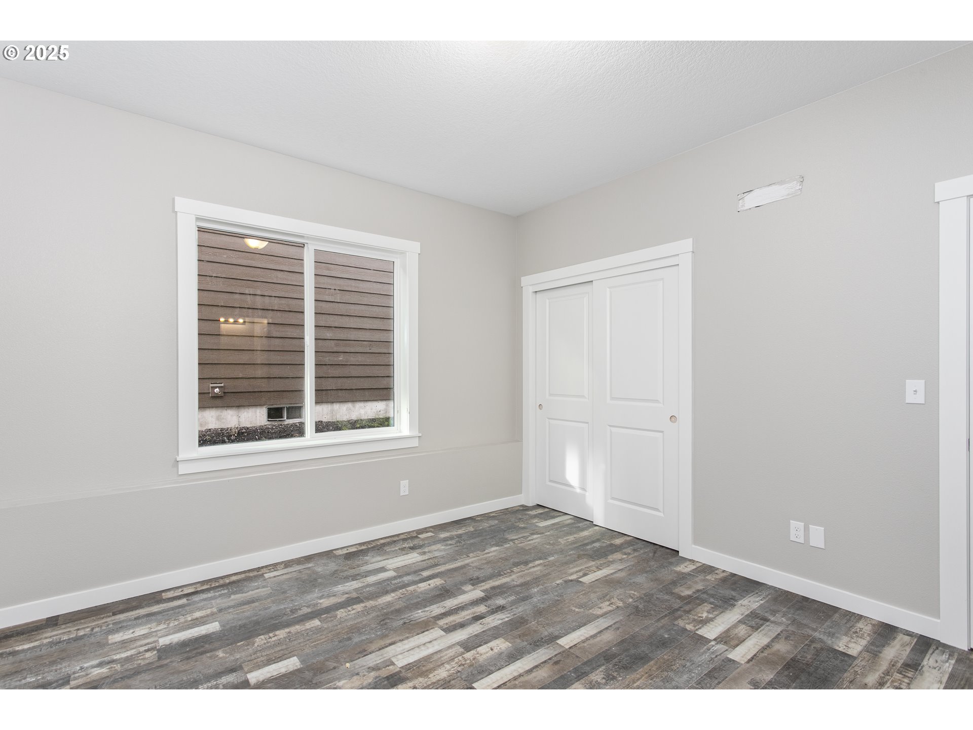158 East H Street Vernonia, OR 97064 - Photo 14 of 33 a view of an empty room with wooden floor and a window
