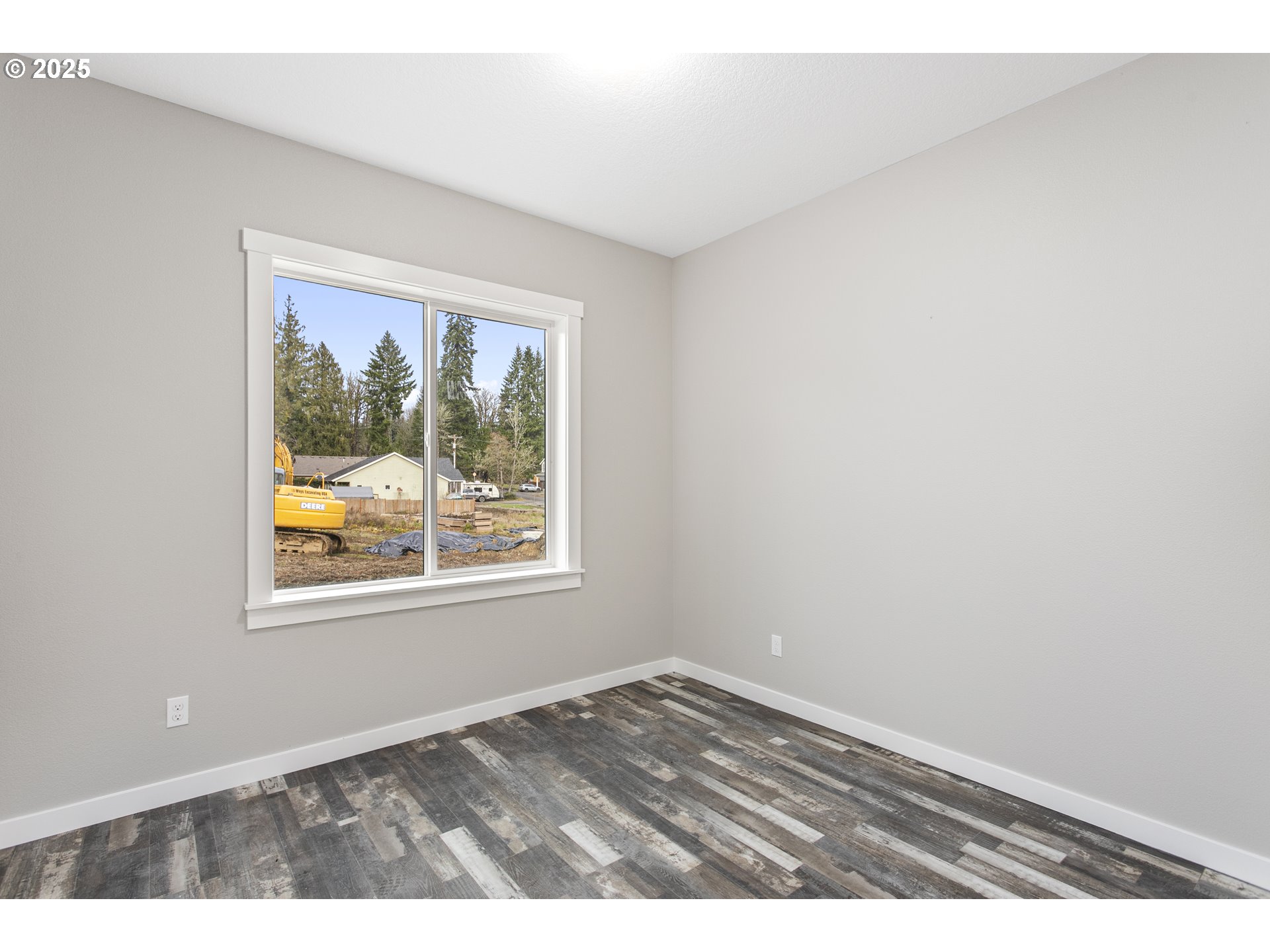 158 East H Street Vernonia, OR 97064 - Photo 16 of 33 an empty room with wooden floor and windows