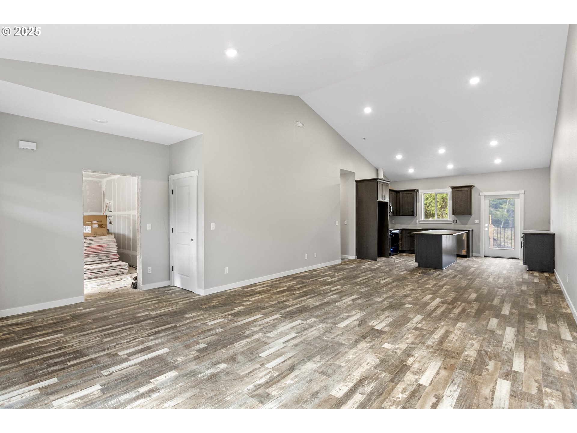 158 East H Street Vernonia, OR 97064 - Photo 3 of 33 a view of a kitchen with kitchen island refrigerator sink and wooden floor