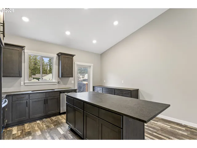 a kitchen with a sink a window and appliances