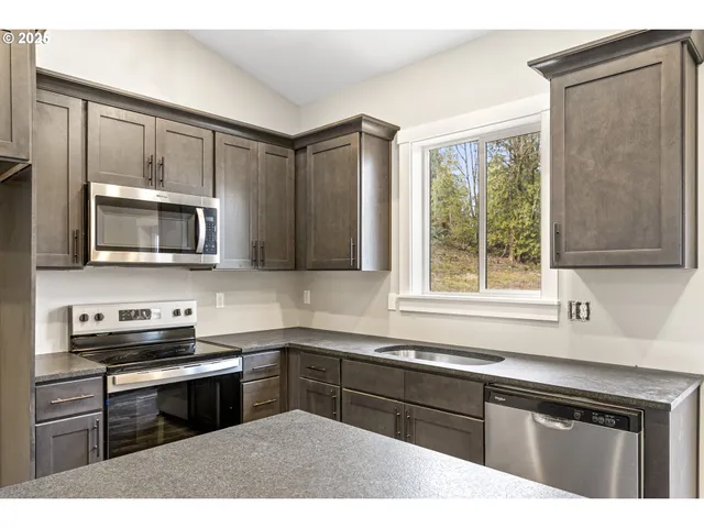 a kitchen with a sink stove and microwave