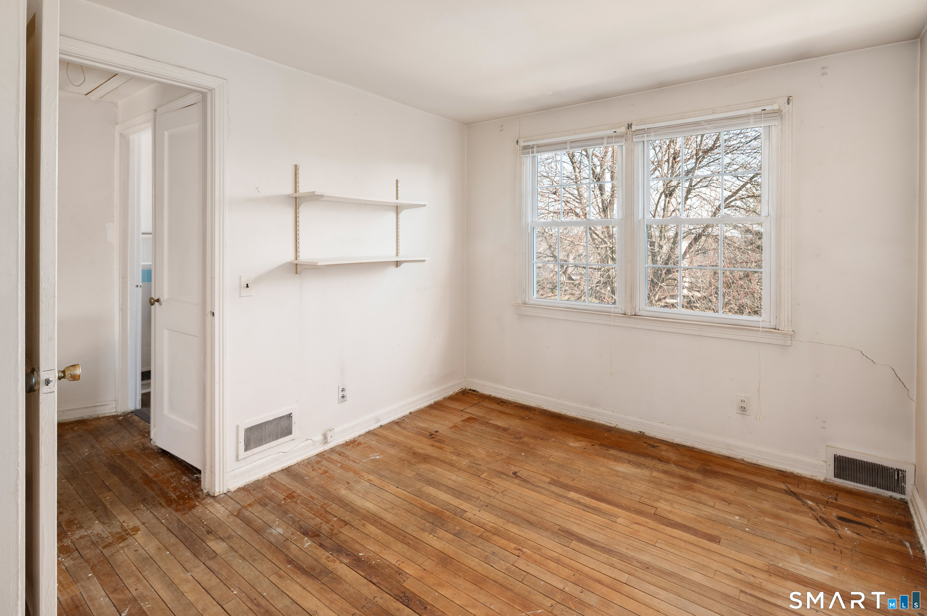 221 Sylvan Knoll Road Stamford, CT 06902 - Photo 11 of 22 an empty room with wooden floor and windows