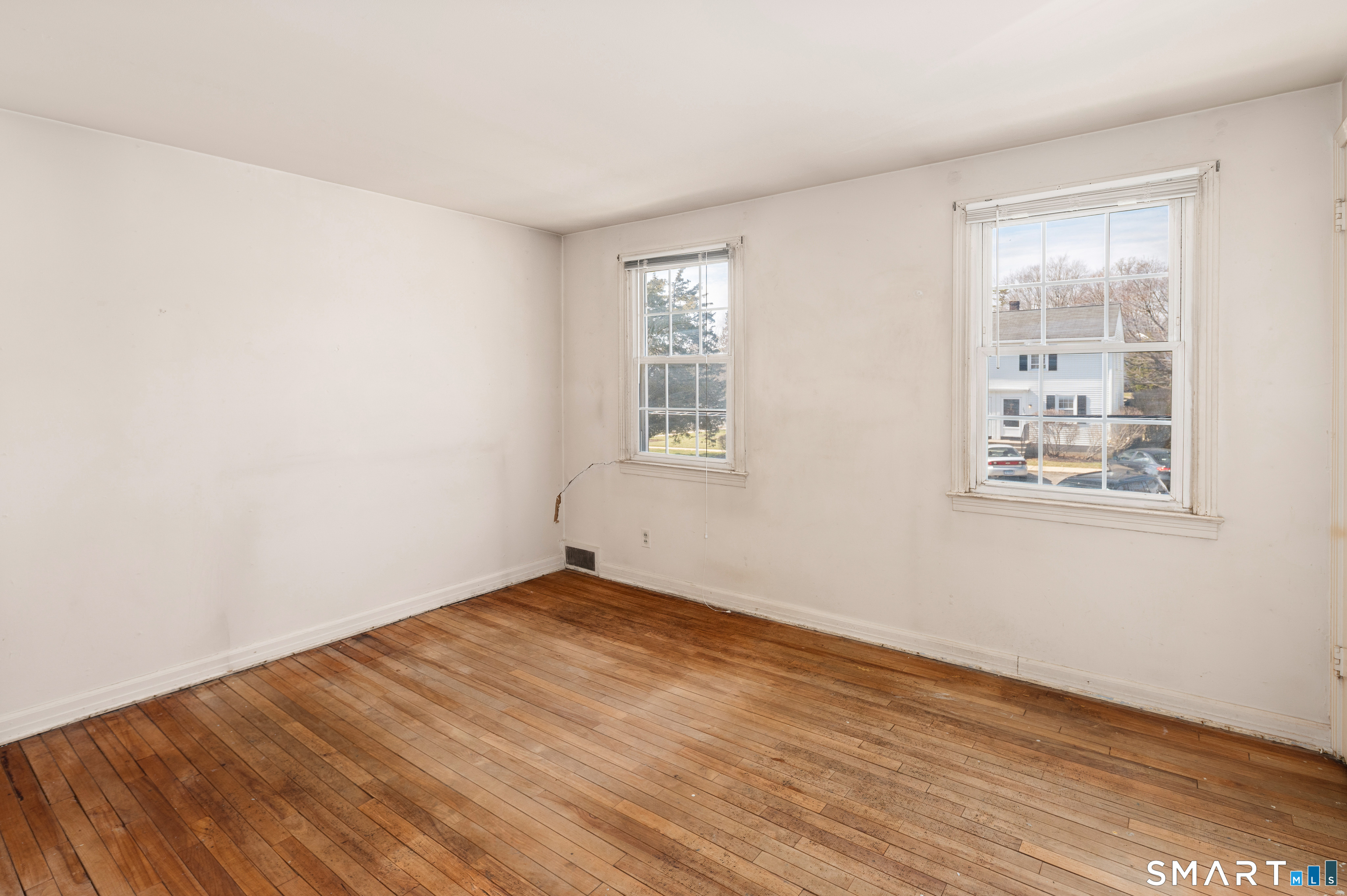 221 Sylvan Knoll Road Stamford, CT 06902 - Photo 15 of 22 an empty room with wooden floor and windows