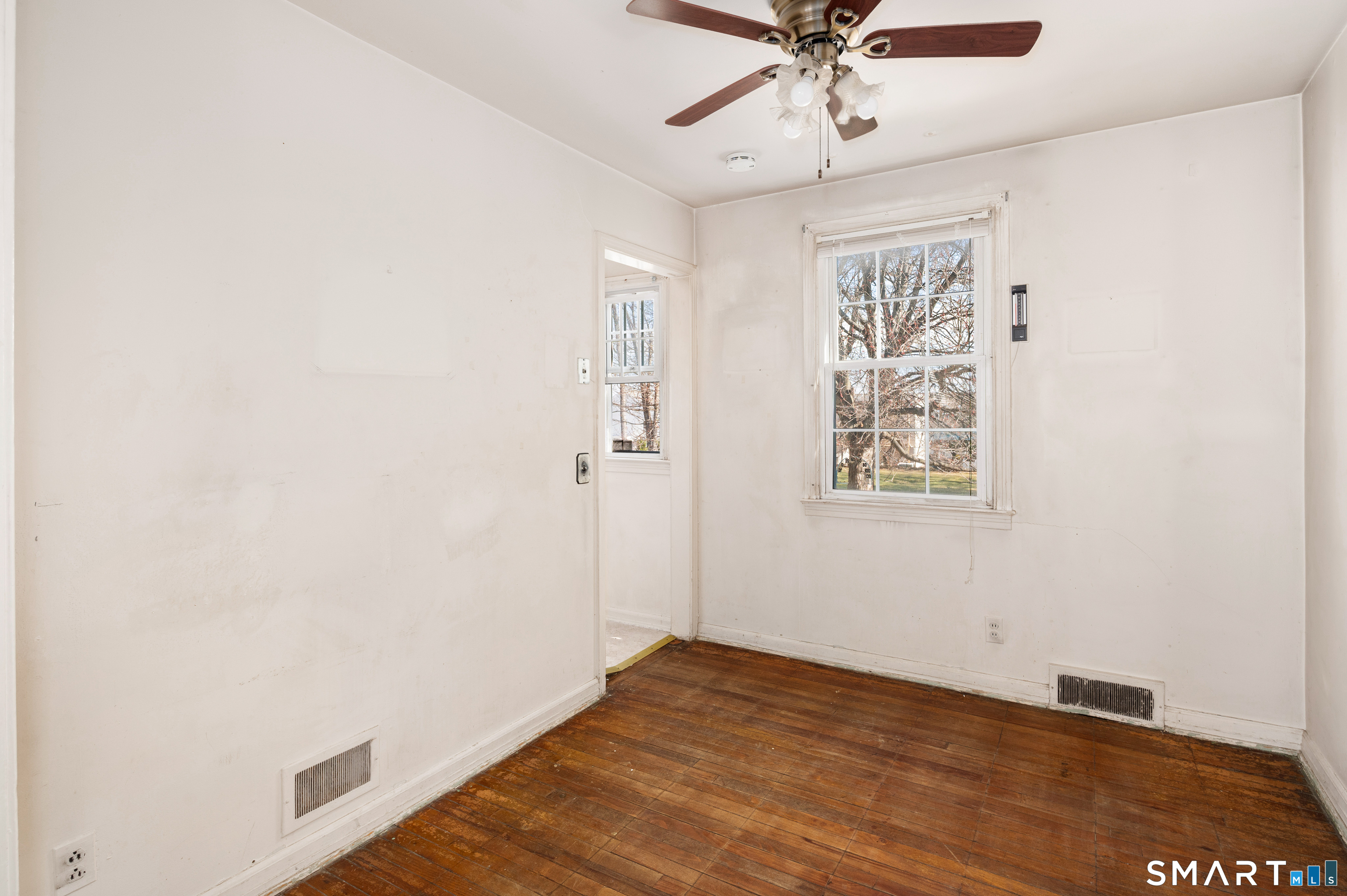221 Sylvan Knoll Road Stamford, CT 06902 - Photo 7 of 22 a view of a livingroom with a window and a ceiling fan