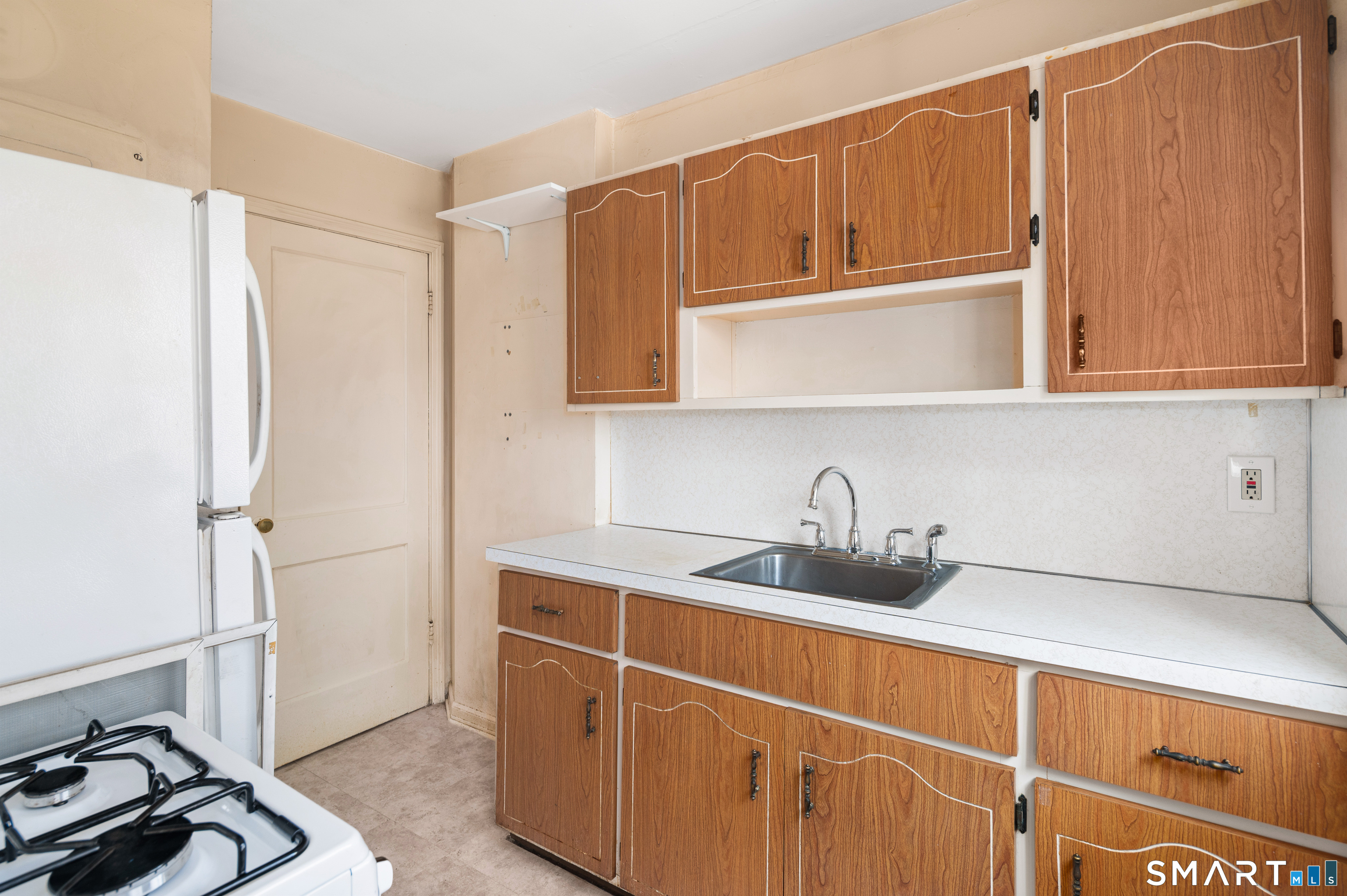 221 Sylvan Knoll Road Stamford, CT 06902 - Photo 9 of 22 a kitchen with stainless steel appliances granite countertop a sink cabinets and a refrigerator