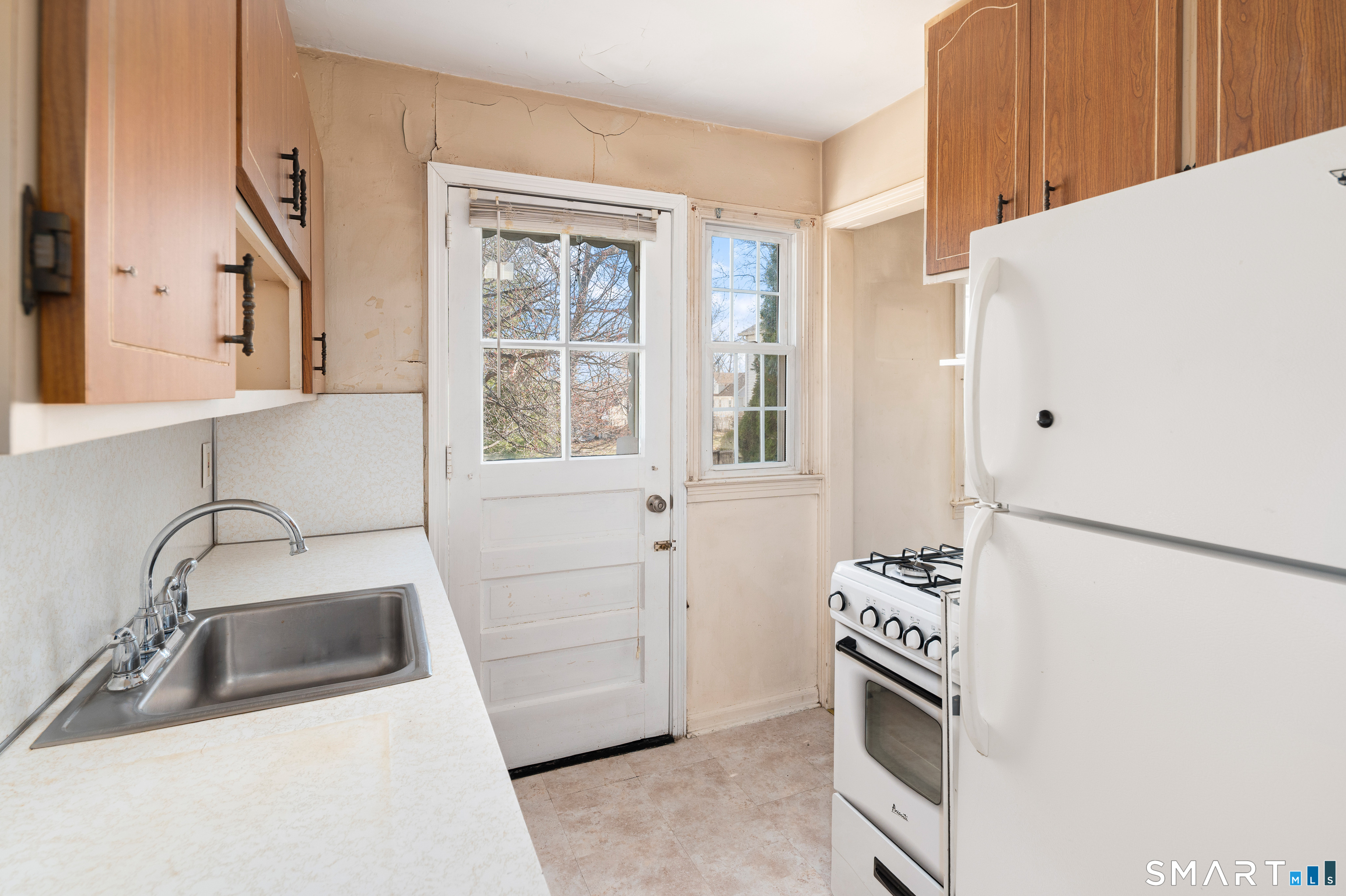 221 Sylvan Knoll Road Stamford, CT 06902 - Photo 10 of 22 a kitchen with a refrigerator and a sink