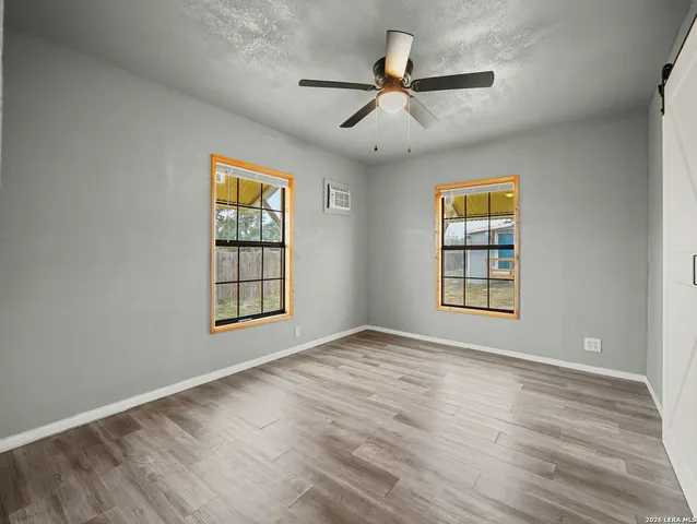 a view of empty room with wooden floor